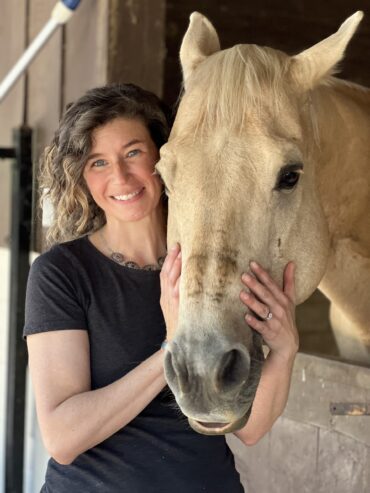 Woman with Palamino horse.